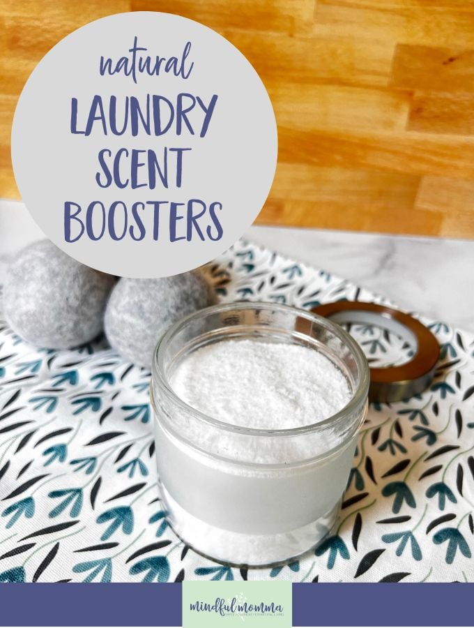 natural laundry scent booster powder in a glass jar and some wool dryer balls