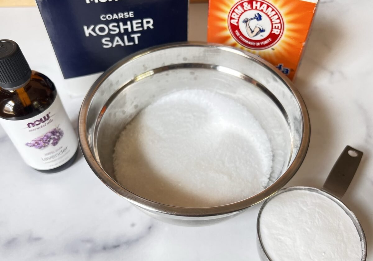 ingredients for homemade laundry scent booster: kosher salt, baking soda and essential oils.