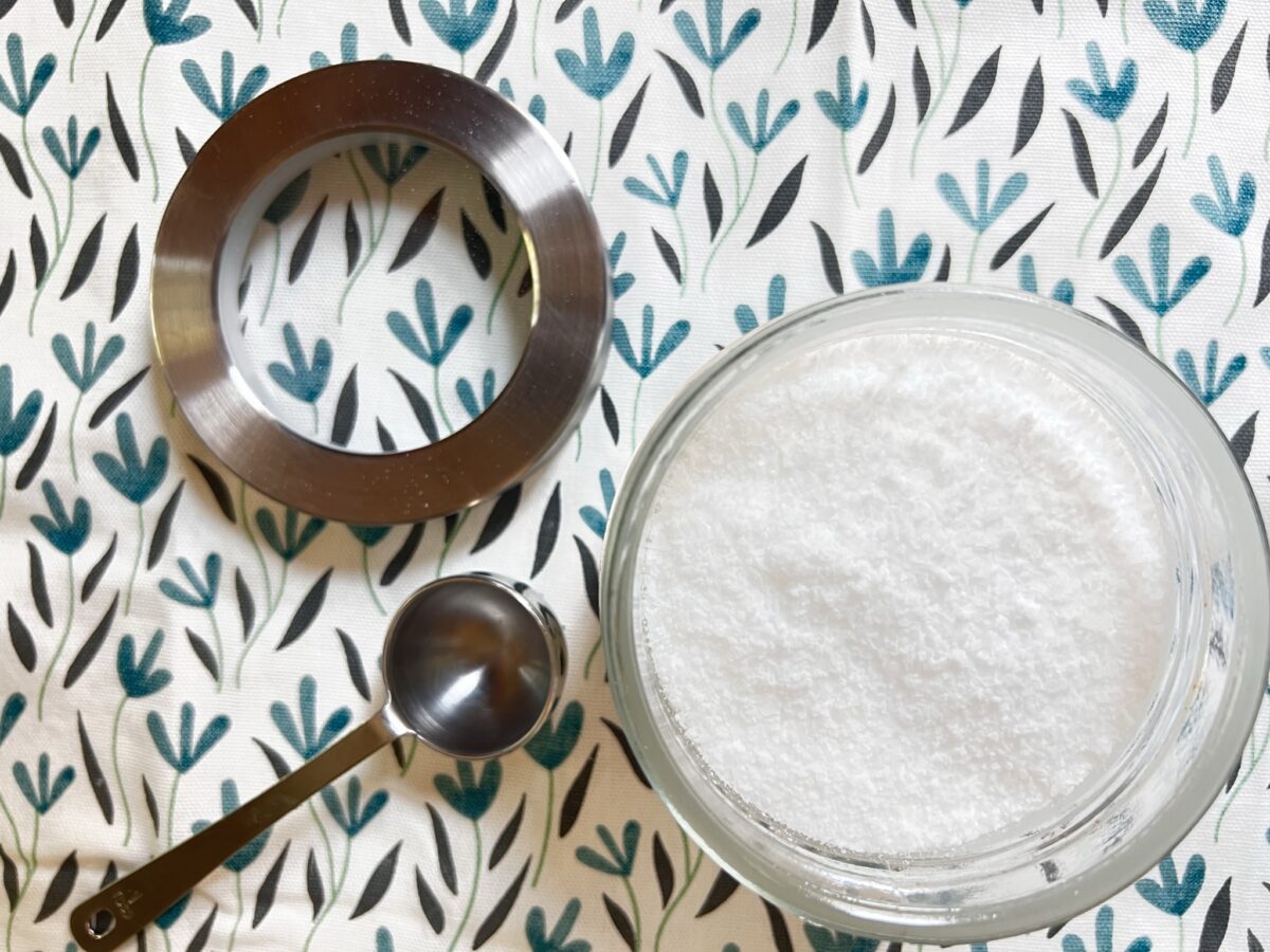 homemade laundry scent booster on cloth with metal scoop