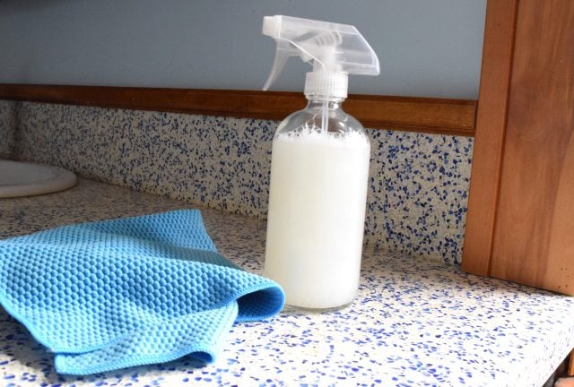 homemade mold prevention spray in glass bottle.