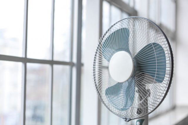 fan in window in house